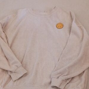 Cozy Cream Sweater with Smiley Patch